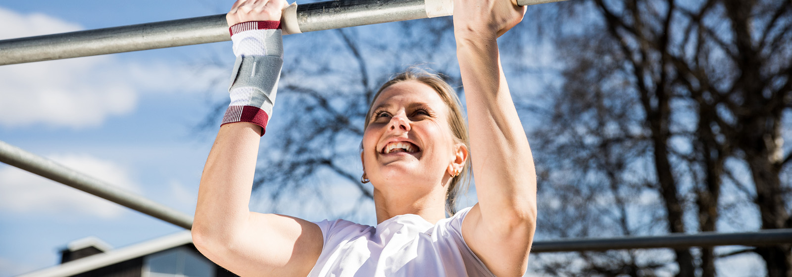 Kvinne øvelser med vektstang i en park Kvinne øvelser med vektstang i en park